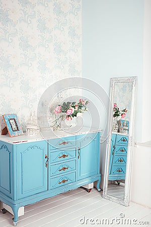 Blue table, a framed photo, flowers in a vase Stock Photo