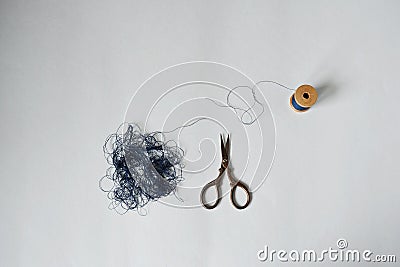 Blue tangle thread spool and retro scissors Stock Photo