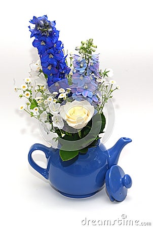 Blue teapot with bouquet Stock Photo