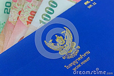 Blue Thai Work Permit book & x28;WP.11& x29; on Thai Baht banknote money Stock Photo