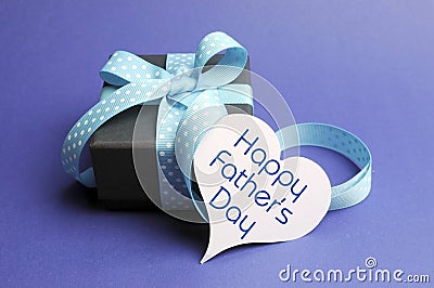 Happy Fathers Day blue theme gift and message on heart tag Stock Photo