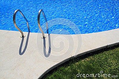Blue tiles swimming pool with green grass garden Stock Photo