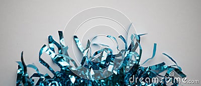 Blue tinsel at white background, glittering and shiny Stock Photo