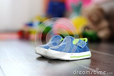 Blue tiny shoes on wooden floor Stock Photo
