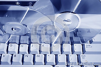 Blue toned keyboard and discs Stock Photo