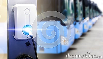 Blue tourist buses on parking and Power supply for electric car charging. Electric car charging station. EV Car battery charger at Stock Photo