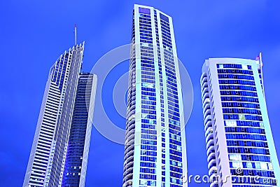 Three modern towers against sky by blue hour Stock Photo