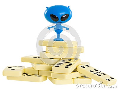 Blue toy alien on a heap from dominoes Stock Photo