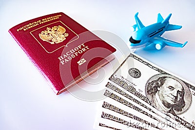 Blue toy plane, russian international passport and cash dollars on white background. Travel, migration and downshifting concept Stock Photo