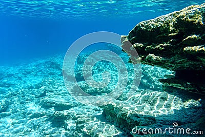 Blue transparent water and pitfalls of the Aegean Sea, seascape. Underwater photography, selective focus. Stock Photo