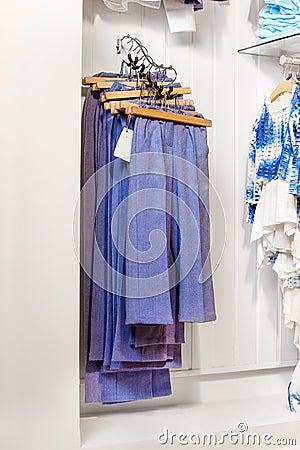 Blue trousers and jeans hanging in the shop Stock Photo