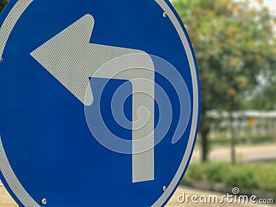 blue turn left sign on pole Stock Photo