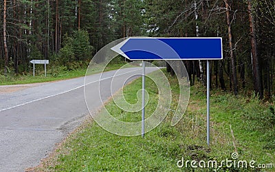 Blue turn signal to the left, to the right of the road, under your text. Close up Stock Photo