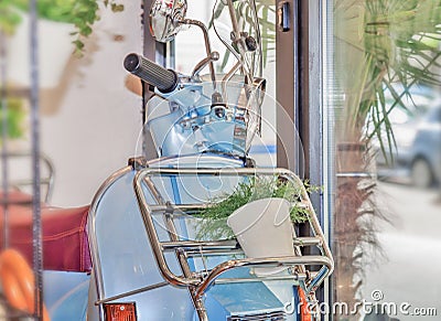 Blue Vespa in coffee shop Stock Photo