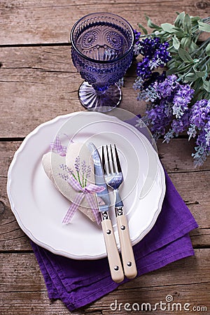 Blue and violet flowers, heart, knife and fork on white plate Stock Photo