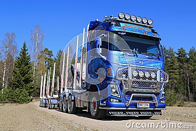 Blue Volvo FH16 750 Timber Truck on Rural Road Editorial Stock Photo