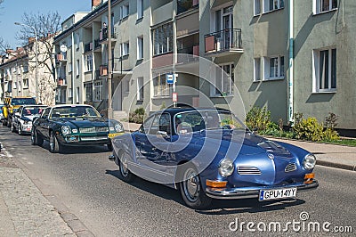 Blue VW Karmann Ghia driving with old cars Editorial Stock Photo