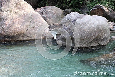 In blue water bolder laying Stock Photo