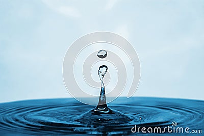 Blue Water Drop Landing in a Pool Stock Photo