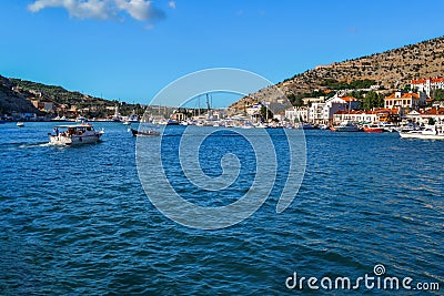 blue water with waves in bay of mountain town of Balaklava with marinas, white ships, boats and bright buildings, ripples Editorial Stock Photo