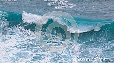 Blue and white breaking ocean wave seen from above Stock Photo