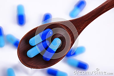 Blue and white capsules pill on white background with shadow. Global healthcare concept. Antibiotics drug resistance. Stock Photo