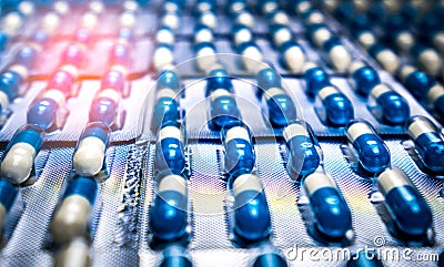 Blue and white capsules pill in blister pack arranged with beautiful pattern. Global healthcare concept. Antibiotics drug Stock Photo