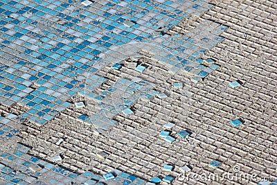 Blue and white ceramic tiles in abandoned swimming pool. Stock Photo