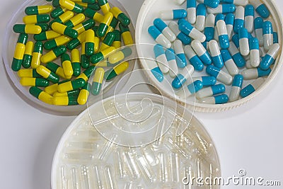 Blue white green yellow and transparant capsule drug Stock Photo