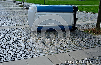 blue white plastic mobile toilet lying on its side Stock Photo