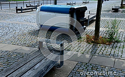 blue white plastic mobile toilet lying on its side Stock Photo