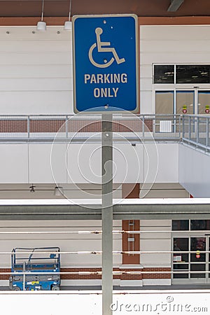 A blue and white reserved parking sign mounted on a metal pole Stock Photo