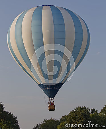Blue and White Striped Balloon Taking off Editorial Stock Photo