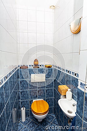 Blue white tiled toilet room with sink Stock Photo