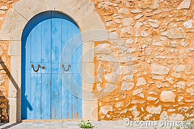 Blue wood door and rustic stone wall of mediterranean house Stock Photo