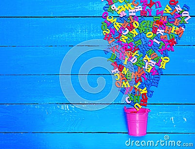 Blue wooden background with multicolored wooden letters Stock Photo