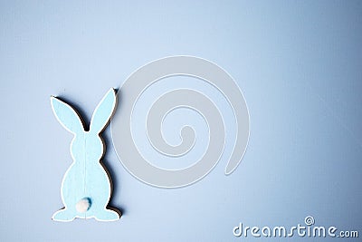 Blue wooden flat easter bunny lies on a blue Stock Photo