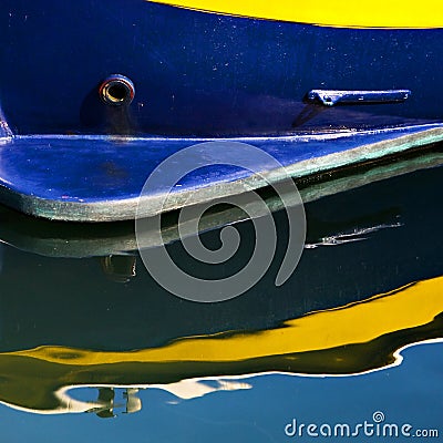 Blue and Yellow Boat with Reflection Stock Photo