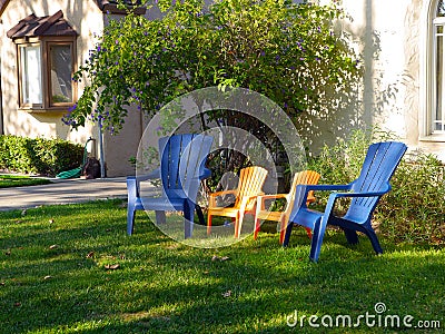 Blue and yellow chairs in the front yard Stock Photo