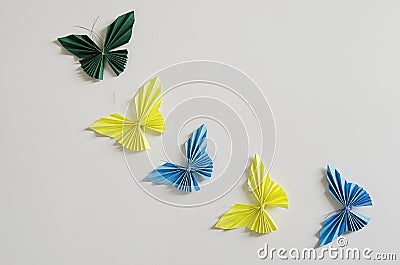 Blue and yellow origami butterflies on white background Stock Photo