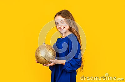 Blue and yellow. Shimmering glitter. Prepare decorations in advance. Girl hold golden ball decorations. Decorative Stock Photo