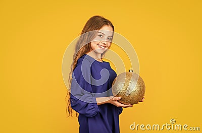 Blue and yellow. Shimmering glitter. Prepare decorations in advance. Girl hold golden ball decorations. Decorative Stock Photo