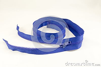 Blue zipper twisted spiral on a light cloth Stock Photo