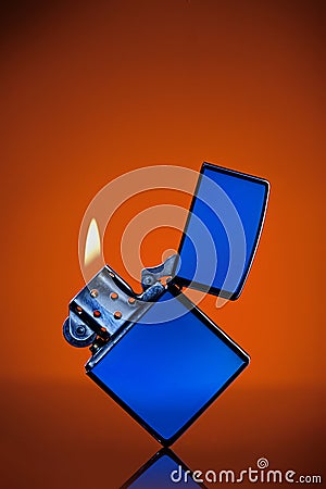 Blue zippo lighter on orange Stock Photo