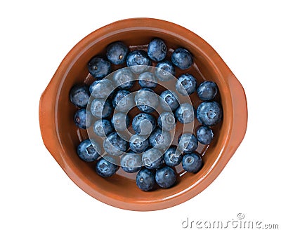 Blueberries in a clay plate isolated on a white background. Fresh bilberry. Flatlay closeup. Stock Photo