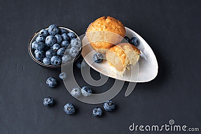 Blueberry antioxidant organic superfood in ceramic bowl and sweet muffin Stock Photo