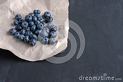 Blueberry antioxidant organic superfood in a paper packaging concept for healthy eating and nutrition Stock Photo