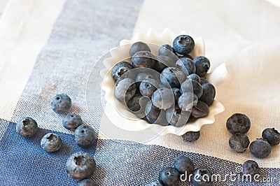 Blueberry closeup. Freshly picked blueberries in wooden bowl over rustic background. Stock Photo