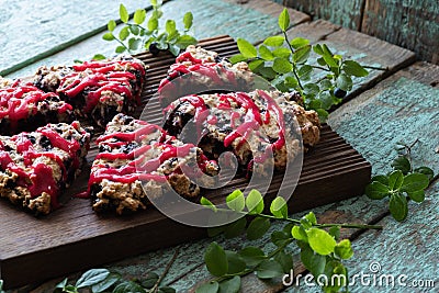 Blueberry cutted scones on oak cutboard with blueberry leaves with old painted wood Stock Photo