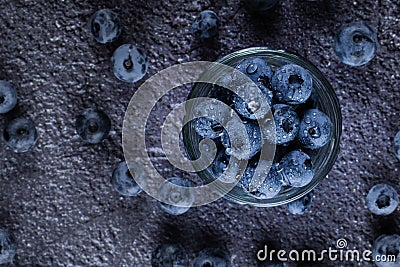 Blueberry in glass plate top view. Blueberries organic natural berry with water drops on dark background. Stock Photo